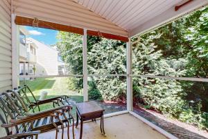 a screened in porch with chairs and a table at The Reserves of Nassau - 17295 Queen Anne Way in Lewes