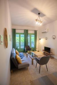 a living room with a couch and a table at Morning Glory Apartment in Paralia Katerinis