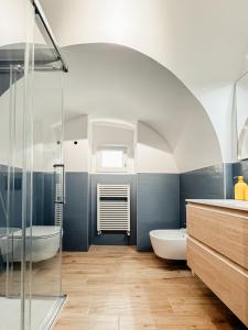 a bathroom with a shower and a tub and a sink at Aparthotel Camere del Capitolo in Bisceglie
