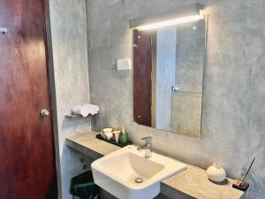 a bathroom with a sink and a mirror at Nilaveli Bay Villa by Ceylon Spaces in Nilaveli +54 photos