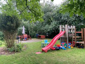 a playground with a slide in the grass at Poddasze Pierwoszyno in Pierwoszyno