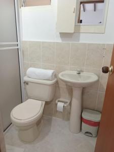 a bathroom with a toilet and a sink at Hotel Nattivo Uraba in Apartadó +41 photos