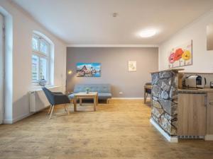 a living room with a couch and a fireplace at Ferienwohnung in der Mecklenburger Seenplatte in Buchholz