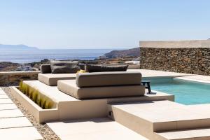 a living room with a couch and a swimming pool at casa eterna in Agios Romanos
