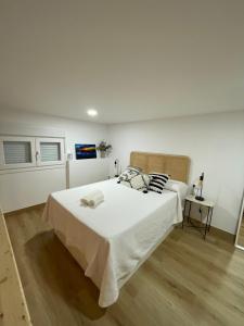 a bedroom with a large bed with white sheets at Apartamento de la Luz in Tarifa