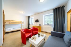 a living room with a couch and two chairs and a bunk bed at Resort Pasečná in Přední Výtoň +116 photos