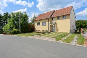 a yellow house on the side of a road at VILA FAMELIA VALTICE Adults Only in Valtice