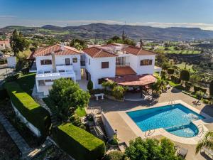 an aerial view of a house with a swimming pool at Mountain view 6 bed mansion with Private Padel Court, Pool & Gym in Larnaca