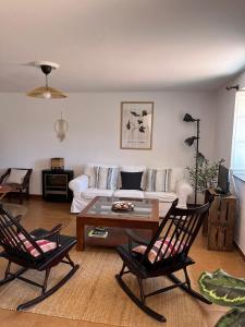 a living room with a white couch and two chairs at Casa Germán in A Coruña +27 photos