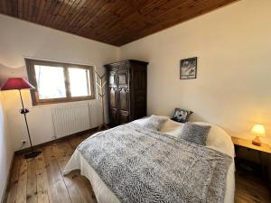 a bedroom with a bed and a window at Chalet Le Chatelret - LE CHATELRET MAE-9361 in Vars