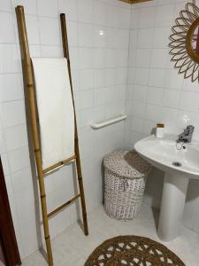 a white bathroom with a sink and a toilet at Casa Germán in A Coruña