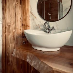 a bathroom with a white sink and a mirror at Skroviste, Zlatibor-Vodice in Zlatibor +52 photos