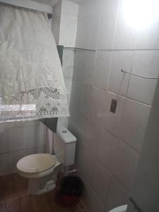a small bathroom with a toilet and a shower at Suites casa da lucia in Salvador +43 photos