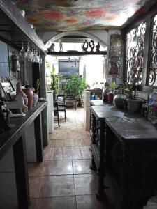a kitchen with a table and some pots and pans at Suites casa da lucia in Salvador