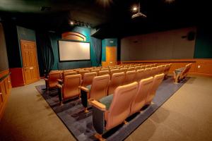 an empty lecture hall with chairs and a screen at Vacation Fantasia - Mins to Disney - Pool & Hot Tub in Kissimmee +33 photos