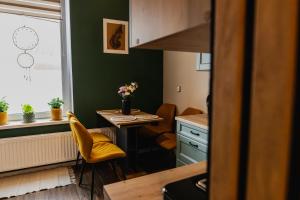 a small kitchen with a small table and a window at Mikroklimat in Nowa Ruda