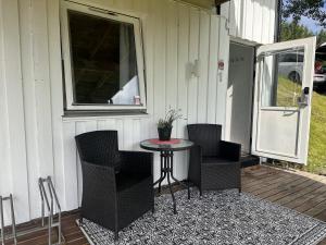 a patio with chairs and a table on a porch at Studio apartment in the center of Alta in Alta +23 photos