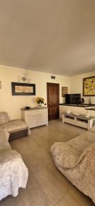 a large room with two beds and a television at Casa Stella in Torre Grande +12 photos