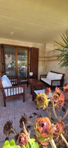 a living room with benches and tables and windows at Casa Stella in Torre Grande