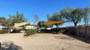 a patio with a fence and a yellow covering at TAIGA Almeria Playa in Palomares