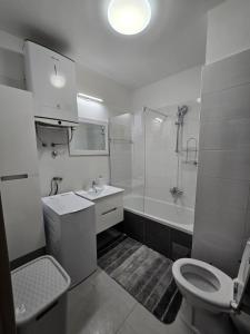 a bathroom with a toilet and a sink and a shower at Amore in Zadar