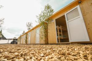 a row of houses with doors on the ground at LivinGood by PartyStadl in Flatschach