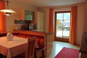a kitchen with a table and a table and a window at Apartment Nockspitze in Innsbruck