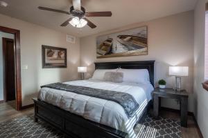 a bedroom with a bed and a ceiling fan at Fun House #265 w Water Park & Golf Cart in Arnolds Park