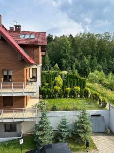a view of a garden from a house at Apartament Rodo in Polanica-Zdrój +10 photos