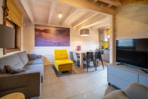 a living room with a couch and a table at Górskie Wytchnienie in Jelenia Góra