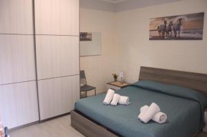 a bedroom with a bed with two pillows on it at Spiaggia LazzarettoHouse in Alghero