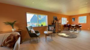 a living room with a couch and chairs and a table at Reine Superior Panorama House in Reine
