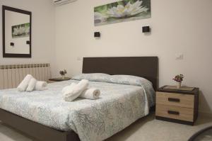 a bedroom with two beds with white towels on them at Spiaggia LazzarettoHouse in Alghero