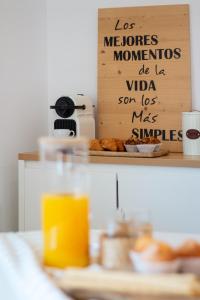 a table with a sign with some bread on it at Apartamento Rincón Playa Carril in Vilagarcia de Arousa