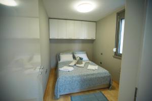 a bedroom with a bed with two towels on it at Elly in Ankaran