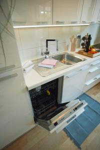a kitchen with a sink and a microwave at Elly in Ankaran +25 photos