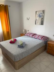 a bedroom with a bed with two hats on it at Apt Los Cristianos Beach 1 in Los Cristianos +8 photos
