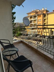 a balcony with chairs and a view of a city at Студио Мая in Sunny Beach