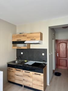 a kitchen with a sink and a counter top at Студио Мая in Sunny Beach