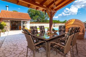a patio with a table and chairs on a patio at Villa Nika in Konjevrate