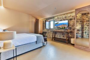 a hotel room with a bed and a desk at Boutique hotel Ruzmarin SPA & Garden by Aycon in Budva