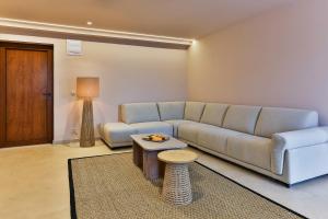 a living room with a couch and a table at Boutique hotel Ruzmarin SPA & Garden by Aycon in Budva