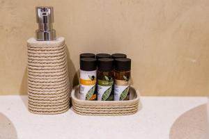 a group of five spices in a basket on a counter at Boutique hotel Ruzmarin SPA & Garden by Aycon in Budva