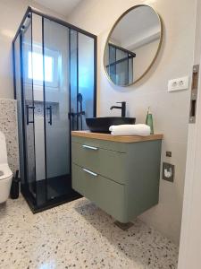 a bathroom with a sink and a mirror at Apartman Villeto in Stari Grad