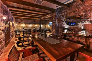 a dining room with tables and chairs and a mirror at Boutique hotel Ruzmarin SPA & Garden by Aycon in Budva