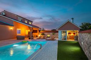 a backyard with a swimming pool and a house at Villa Nika in Konjevrate