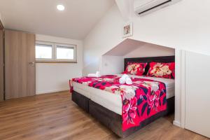a bedroom with a large bed with a red blanket at Villa Nika in Konjevrate +60 photos