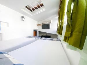 a small bedroom with a bed and a green towel at BOUTIQUE VILLA 84 in Sarajevo