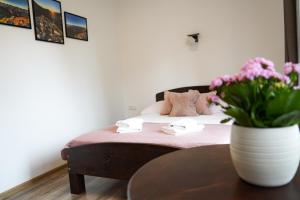 a bedroom with a bed with a vase of flowers at Noclegi u Masnych in Witów +41 photos
