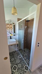 a bathroom with a shower and a sink and a sink at Les 3 Chênes in Puechredon